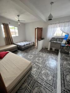 a bedroom with two beds and a couch in it at A CASA DE IRENE IV in Aparecida