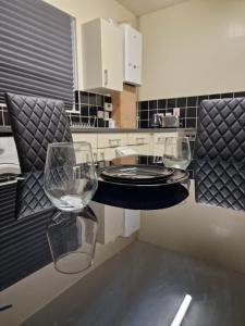 two empty wine glasses sitting on a counter in a kitchen at Spacious and homely one bedroom in London