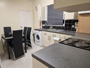 a kitchen with a stove and a counter top at Spacious and homely one bedroom in London