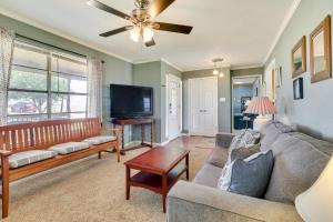 a living room with a couch and a tv at 20 Mi to Austin Texas Farmhouse on 10 Acres in Manor