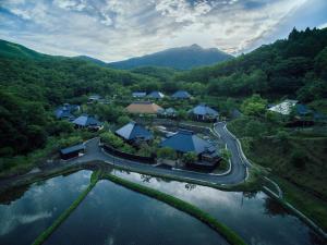 an aerial view of a resort next to a body of water at Miyama Sansou in Minamioguni