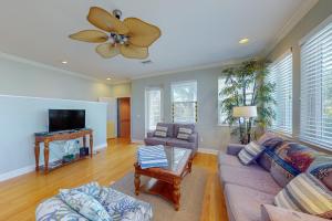 a living room with a couch and a ceiling fan at Coquina Sands in Holmes Beach