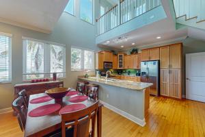 a kitchen with a table with chairs and a counter top at Coquina Sands in Holmes Beach