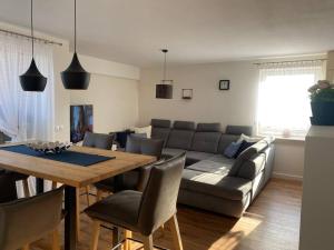 a living room with a couch and a table with chairs at Apartament Holiday Amber in Rewal