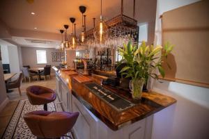 a bar with a counter with stools in a room at The Green Inn in Goole