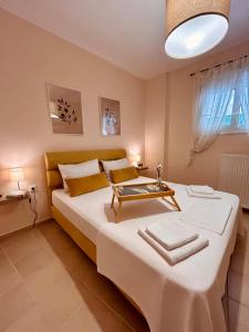 a bedroom with a bed with a table on it at Feel at home - Kalamata - Near the center in Kalamata