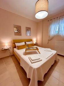 a bedroom with a large bed with a white blanket at Feel at home - Kalamata - Near the center in Kalamata