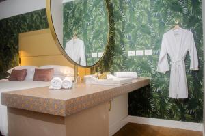 a bathroom with a sink and a mirror at Faranda Collection Barranquilla, a member of Radisson Individuals in Barranquilla