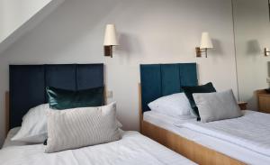 two beds sitting next to each other in a room at Ski Hotel in Piwniczna-Zdrój +30 photos