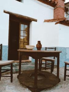 a wooden table with a bowl on top of it at La Casa del Castaño in Aracena +16 photos
