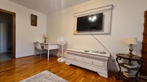 a living room with a flat screen tv on the wall at Apartament Bogdan in Gura Humorului