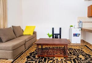 a living room with a couch and a coffee table at KITRA Cozy Homes in Kilifi