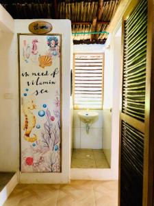 a bathroom with a toilet and a sink at Maria Moñitos Hostel in Moñitos