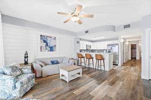 a living room with a couch and a ceiling fan at Calypso 3-2210 - Love Nest in Panama City Beach
