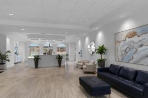 a lobby with a couch and chairs in a building at Calypso 3-2210 - Love Nest in Panama City Beach +35 photos