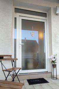 a sliding glass door with a heart hanging on it at Be Home! Apartment Gratkorn in Gratkorn