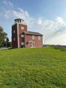 a building with a tower on top of a grass field at Lakeside Oasis/Golf Cart/Beach in Luna Pier +28 photos