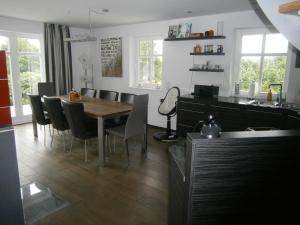 a kitchen and dining room with a table and chairs at Ferienhaus der Winde in Groß Stresow