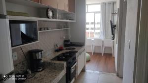 a kitchen with a stove and a counter top at Estilo Bela Vista 308 in Cabedelo