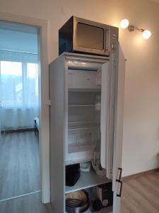 a refrigerator with a tv on top of it at Be Home! Apartment Gratkorn in Gratkorn