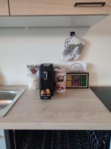 a counter top with a coffee maker and cups on it at Be Home! Apartment Gratkorn in Gratkorn