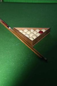 a wooden box of billiard balls on a green table at RL Hotel in Stepʼanavan
