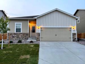 a house with a garage in front of it at Spacious 3 bedroom home in Longmont