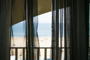 a window with a view of the beach at Yes Hotel Touring & SPA in Rimini