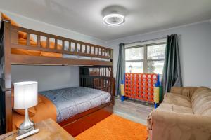 a bedroom with a bunk bed and a couch at Lakefront Retreat in Jefferson with Screened Porch! in Jefferson