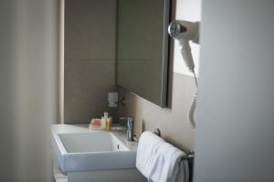 a bathroom with a sink and a mirror at Yes Hotel Touring & SPA in Rimini