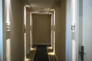 a hallway with doors and lights in a building at Yes Hotel Touring & SPA in Rimini