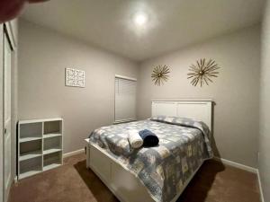 a bedroom with a bed and a clock on the wall at Spacious 3 bedroom home in Longmont