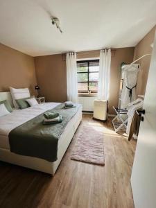a bedroom with a large bed and a window at Das Bergherz Ruhe + Natur pur in Reken