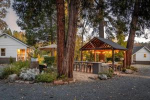 a backyard with a gazebo and tables and trees at Creektown Cottages The Dogwood in Grass Valley