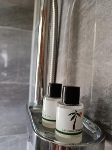 two nail polish bottles sitting in a metal container at Apartman HAX in Sjenica