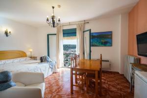 a bedroom with a bed and a dining room table at Doña Ruidera in Ruidera