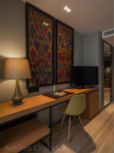 a desk with a lamp and a chair in a room at Descobertas Boutique Hotel Porto in Porto