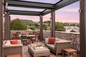 a patio with furniture and a view of the mountains at The Piccolo in Paso Robles