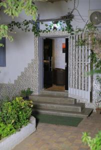 a staircase leading to a house with a white gate at استوديو جراند ماجيك مدخل خاص بحديقه in Cairo