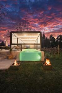 a swimming pool with two fires in the grass at Parronales de Los Boldos in Santa Cruz