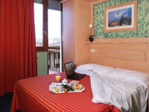 a hotel room with a tray of food on a bed at Hotel Meridiana in Florence