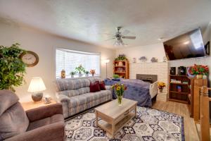 a living room with a couch and a table at Simple and Charming Idaho Retreat with Pellet Smoker in Idaho Falls