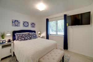 a bedroom with a bed and a large window at Simple and Charming Idaho Retreat with Pellet Smoker in Idaho Falls