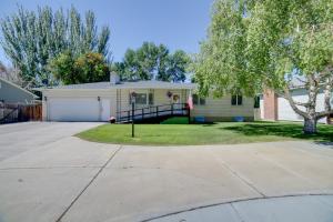 a house with a driveway in front of it at Simple and Charming Idaho Retreat with Pellet Smoker in Idaho Falls