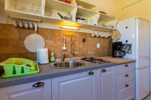 a kitchen with a sink and a counter top at Apartment Lumanera Stivan in Štivan