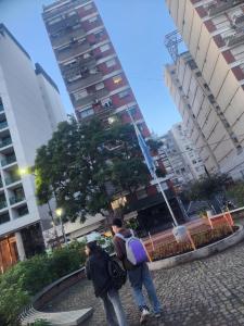 dos personas caminando por una acera en una ciudad en Departamento Palermo Hasta 4 en Buenos Aires