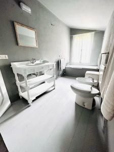 a bathroom with a white sink and a toilet at Veneto Villa in Padua in Villa Osti