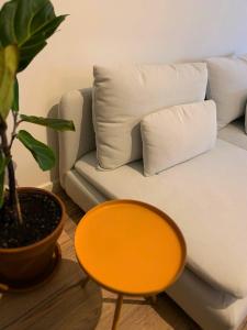 a living room with a couch and a orange table at Nordic! 1 Bedroom Apartment in Puerto de la Cruz