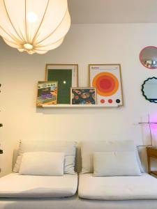 two beds in a room with pictures on the wall at Nordic! 1 Bedroom Apartment in Puerto de la Cruz