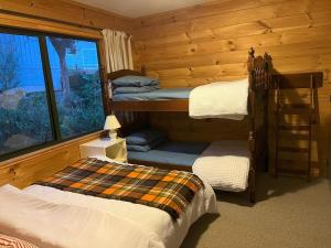 a bedroom with two bunk beds and a window at Waikawa Bay bach with spectacular views in Waikawa